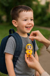 Child holding Shinchan face changing keychain toy