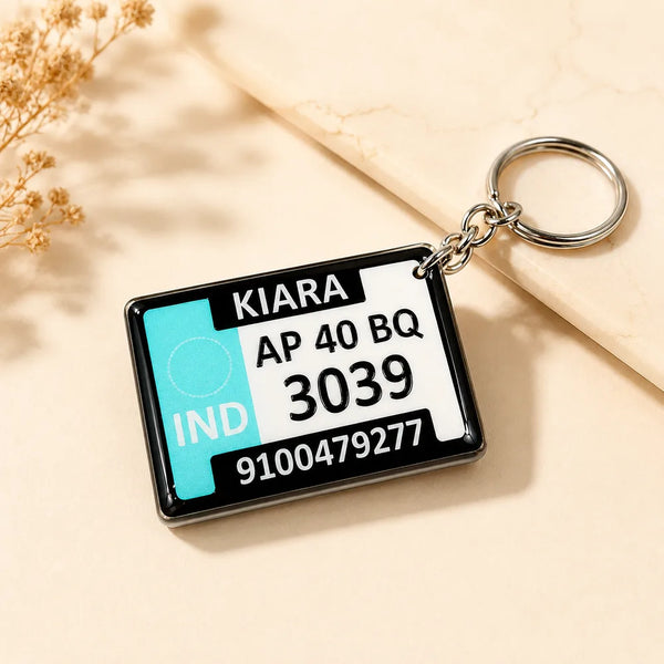 Customizable acrylic gel keychain with name and vehicle number plate print on beige lifestyle background