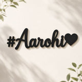 Black '#Aarohi' sign with a heart on a white background

