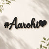 Black '#Aarohi' sign with a heart on a white background