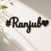 Black decorative nameplate with '#Ranjub' on a light background