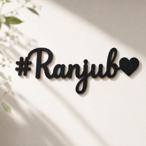 Black decorative nameplate with '#Ranjub' on a light background