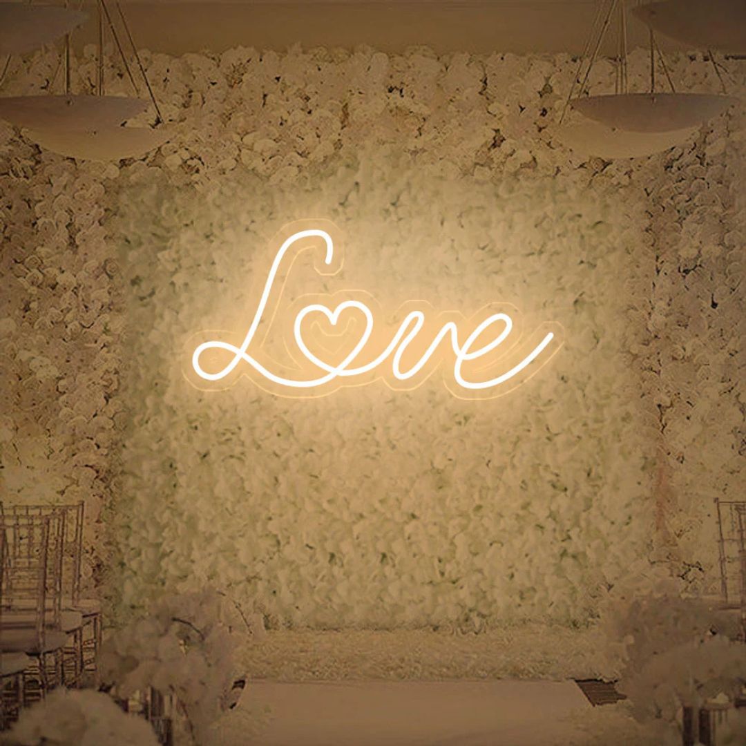 Warm white love neon sign giving cozy romantic light