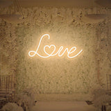 Warm white love neon sign giving cozy romantic light
