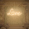 Warm white love neon sign giving cozy romantic light