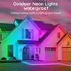 House illuminated with colorful outdoor neon lights against a pink sky.