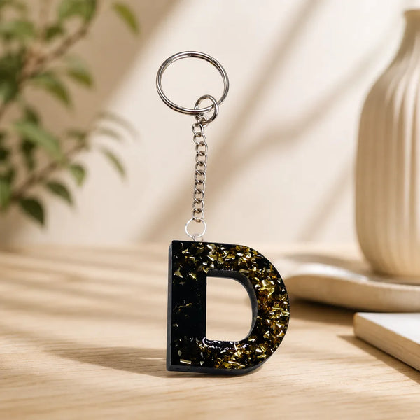 Black and gold personalised letter keychain lifestyle image