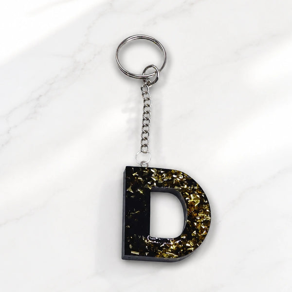 Custom resin initial keychain on clean white background